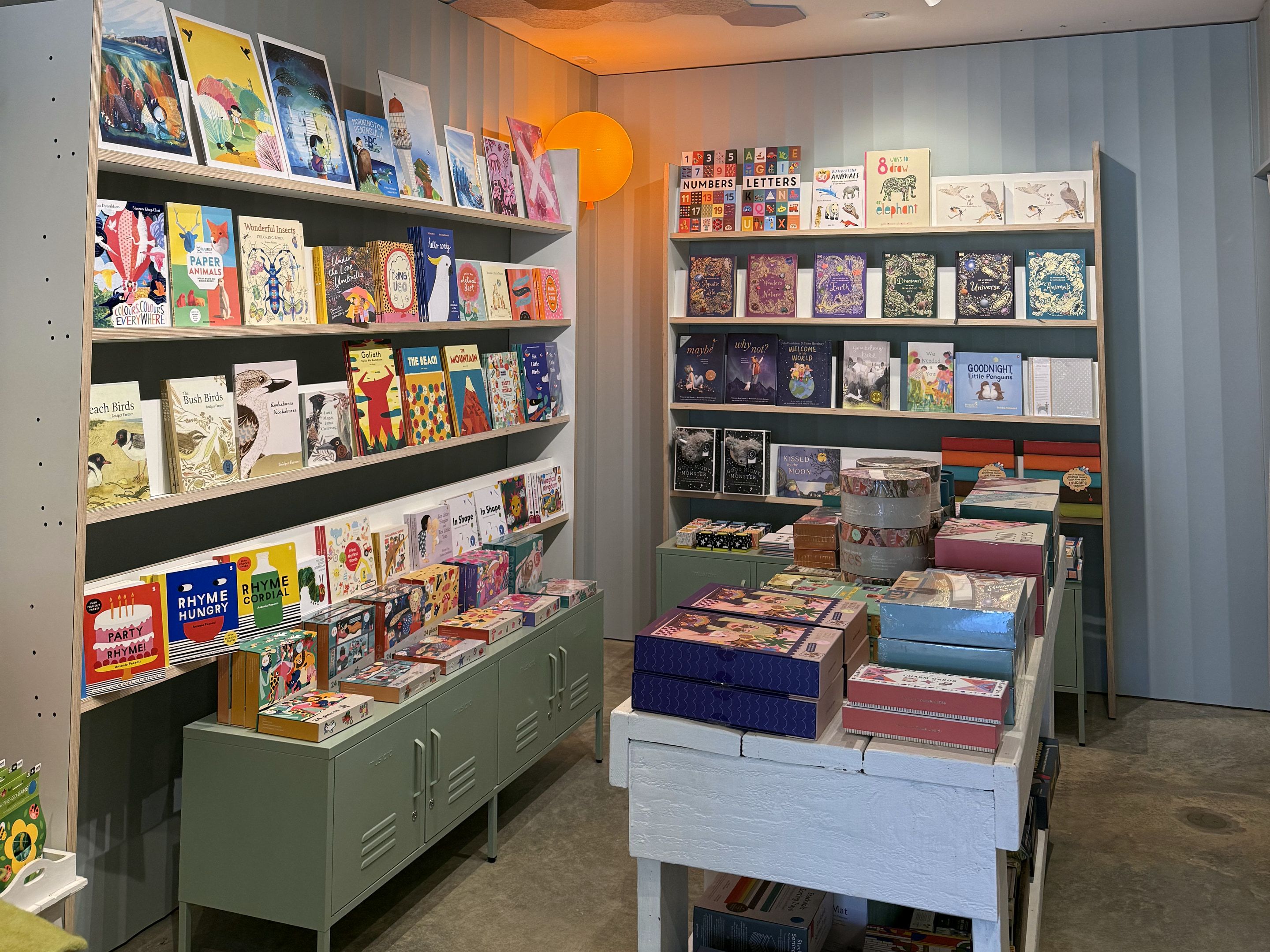 Shelves of children's books and gift boxes in a shop
