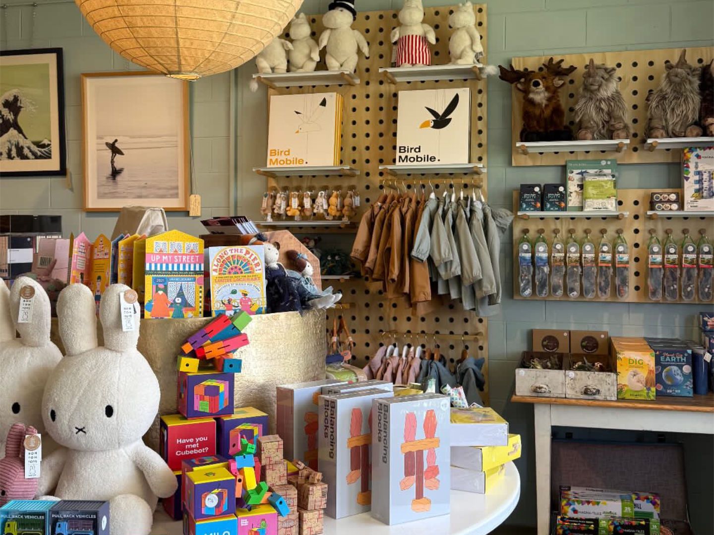 Pegboard display wall with children's toys and clothing