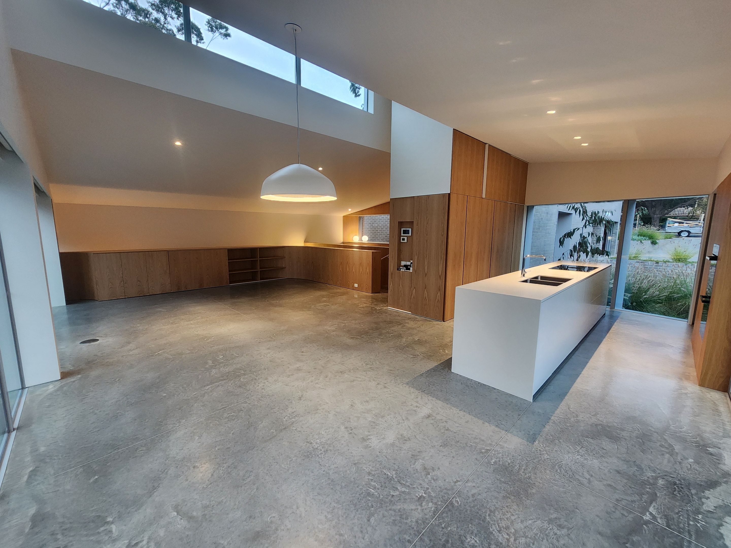 Open-plan living space with a polished concrete floor and kitchen island